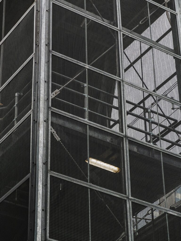 Close-up of an industrial metal mesh facade on a modern building.